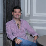 Alejandro Betancourt sitting at a desk in a professional office setting