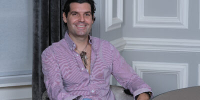 Alejandro Betancourt sitting at a desk in a professional office setting