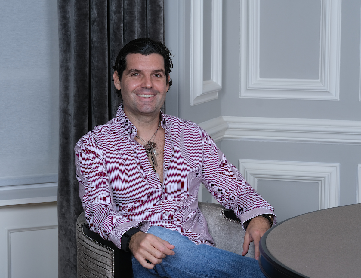 Alejandro Betancourt sitting at a desk in a professional office setting